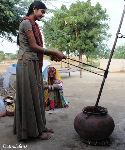 A Girl Churning Buttermilk at Lakshman Sagar, Pali, Rajasthan