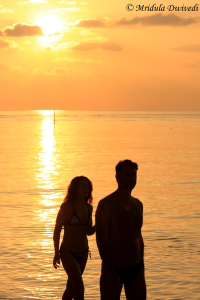 A couple enjoy the sunset at Maafushi, Maldives