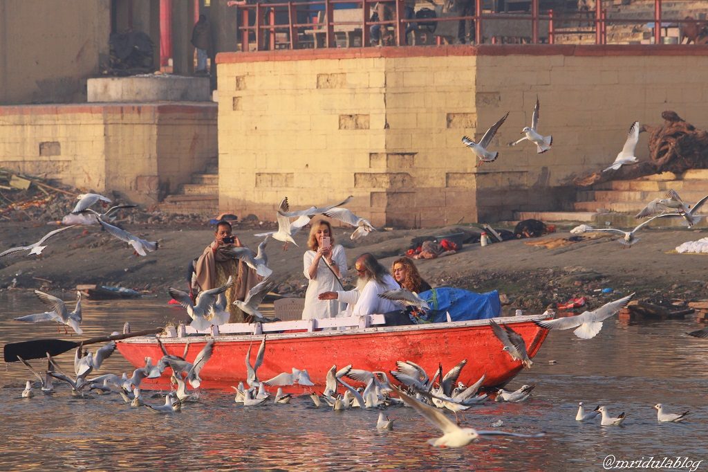 Tourists enjoying the morning boat ride at river Ganga in Varanasi