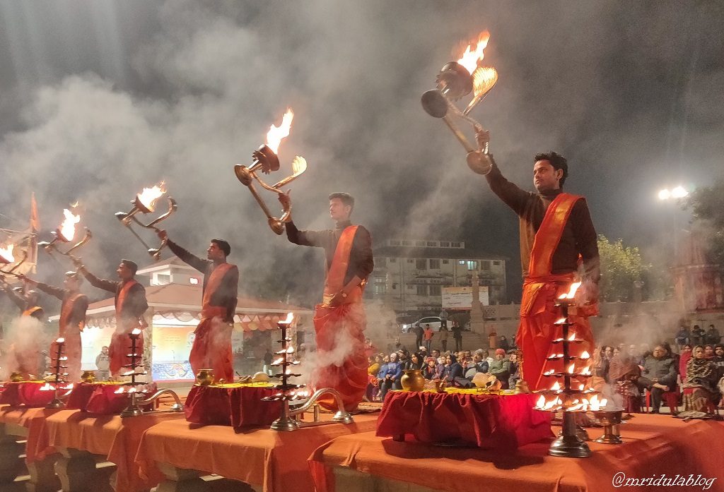 Hindu Persists with lighted lamps performing puja at Banaras