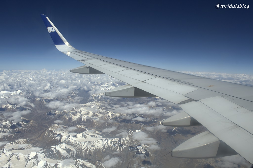 A view of the Ladakh range of mountains along with the wing of the Go Air plane
