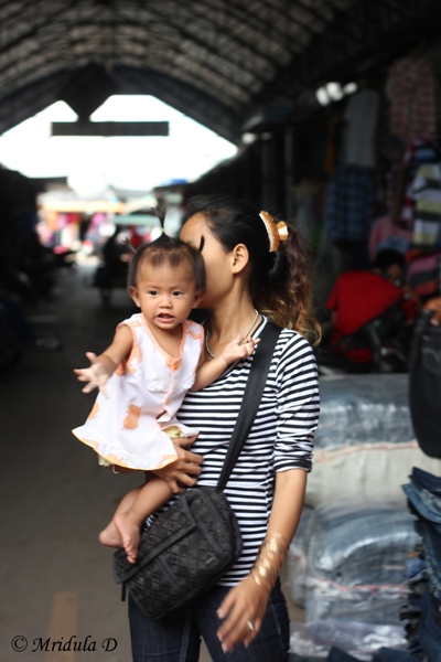 A Girl with Her Mother around Their Shop
