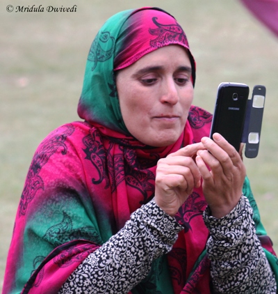 A woman using her cell phone in Srinagar, India
